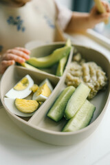 first blw baby food, little baby eating organic vegetables with BLW method. Infant eating healthy food. self feeding