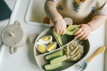 first blw baby food, little baby eating organic vegetables with BLW method. Infant eating healthy...