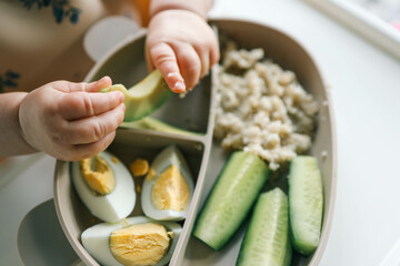 first blw baby food, little baby eating organic vegetables with BLW method. Infant eating healthy food. self feeding