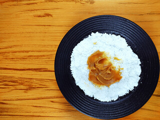 Typical Brazilian snack know as tapioca with dulce de leche on the wooden table. Typical northeastern food. From Brazilian northeast