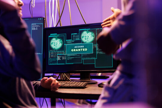 Access granted message on hackers computer screen after breaking into online server. Two criminals happy successful network system password hacking notification on monitor