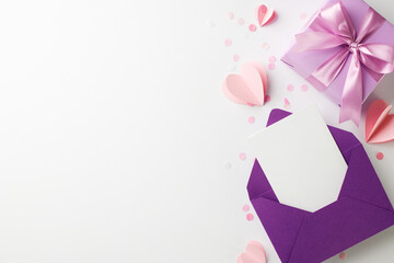 Precious delights: thoughtful gifts for her joyous moments. Top view shot of elegant purple gift box, envelope, heart confetti on white background with space for product promotions