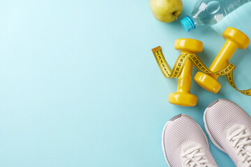 Wellness and workout: charting the course to fitness. Top view shot of yellow dumbbells, measuring...