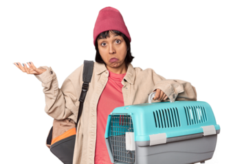 Young Hispanic woman ready for travel with pet carrier having an idea, inspiration concept.