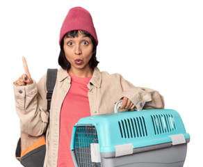 Young Hispanic woman ready for travel with pet carrier being shocked, she has remembered important meeting.