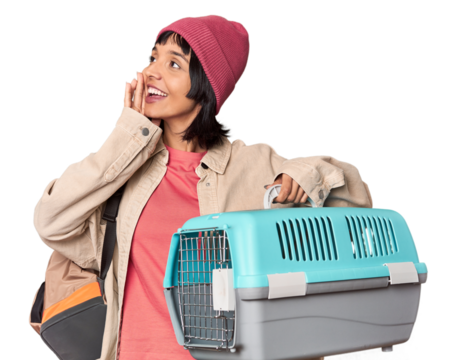 Young Hispanic woman ready for travel with pet carrier touching back of head, thinking and making a choice. - Powered by Adobe