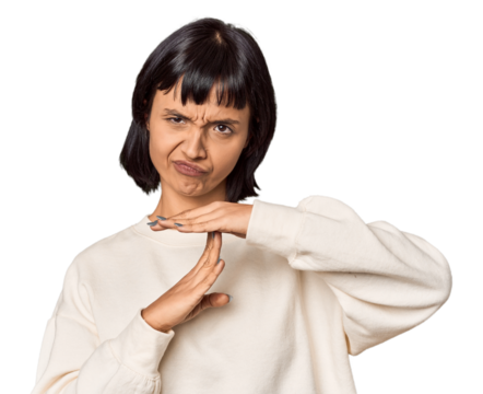 Young Hispanic woman with short black hair in studio showing a timeout gesture.