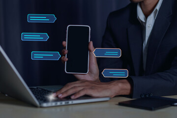 Businessman working on laptop revealing global data and email on smartphone screen.Web 3.0 digital technology concept