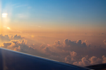 in the morning with a beautiful sunrise above the clouds by plane to Turkey Antalya