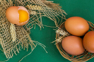 Raw eggs - on green background.