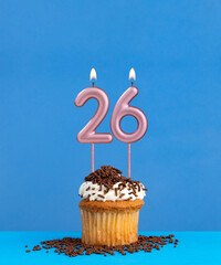 Birthday candle with cupcake on blue background - Number 26
