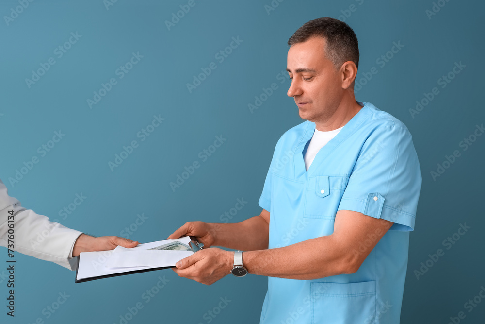 Canvas Prints Mature doctor taking bribe from man on blue background