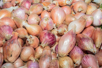Dry onions for sale on the counter of a Mediterranean local outdoor fruit market.
