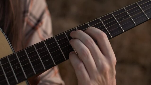 Musicians fingers glide across the fingerboard 