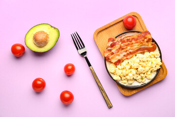 Plate of tasty scrambled eggs with bacon on lilac background