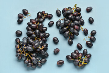 Sweet black grapes on blue background