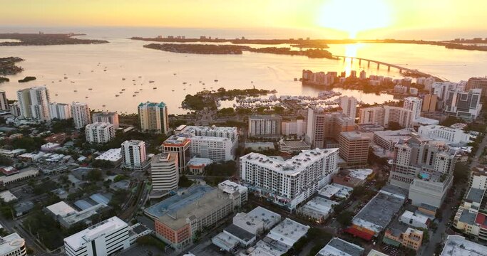 Sarasota city downtown at sunset with high-rise office buildings and Ringling Bridge on horizon. Real estate development in Florida. USA travel destination