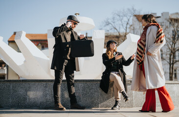 Multicultural business team engaged in winter outdoor meeting in sunlight.