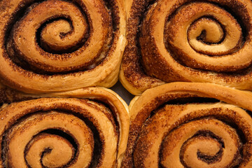 Tasty cinnamon rolls as background, closeup