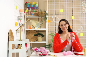 Young woman knitting with needles at home