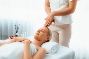 Fotobehang Caucasian woman enjoying relaxing anti-stress head massage and pampering facial beauty skin recreation leisure in dayspa modern light ambient at luxury resort or hotel spa salon. Quiescent © Summit Art Creations