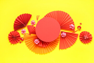 Blank card with fans, beautiful flowers and lanterns on yellow background. Chinese New Year celebration