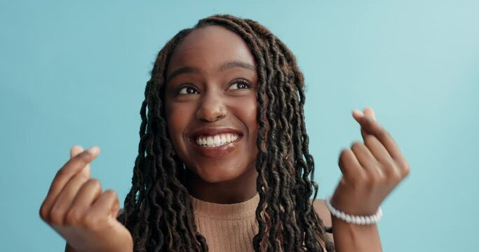 Happy, face and black woman dancing for style, care or fashion on a blue studio background. Portrait of African female person or young model with smile, finger heart or like sign for love on mockup