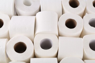 Many soft toilet paper rolls as background, above view