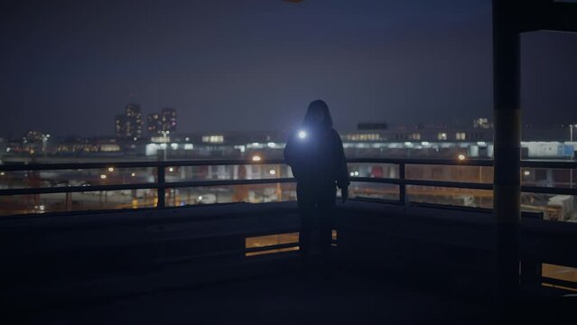Hooded Fearless Woman Walking in Abandoned Urban Town at Twilight Light