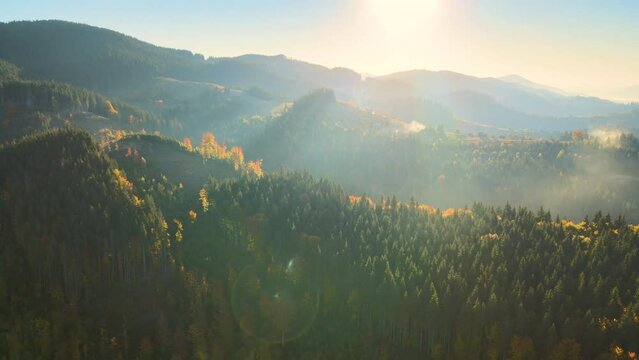 Beautiful panoramic mountain landscape with hazy peaks and foggy valley at sunset