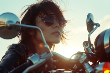 cool looking woman riding a motorcycle with sunglasses