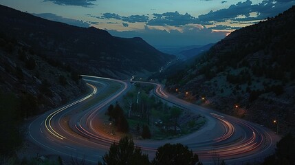As dusk fell, lights and vehicle traces from cars and trucks could be seen circling along a mountain road between circular ravines