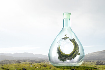 Green sphere landscape inside glass bottle