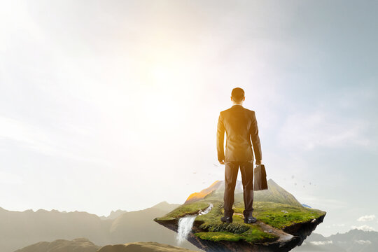 Image of confident businessman in front of stairs