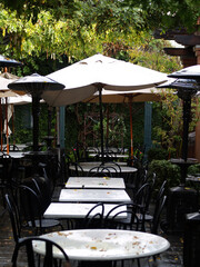 Empty Tables At Small Cafe Wet With Rain