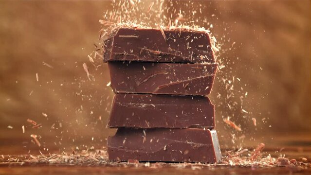 The grated chocolate falls on the chocolate slices. Filmed on a high-speed camera at 1000 fps. High quality FullHD footage