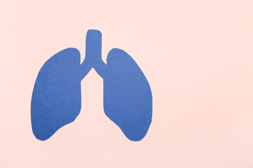 Blue paper lungs on beige background
