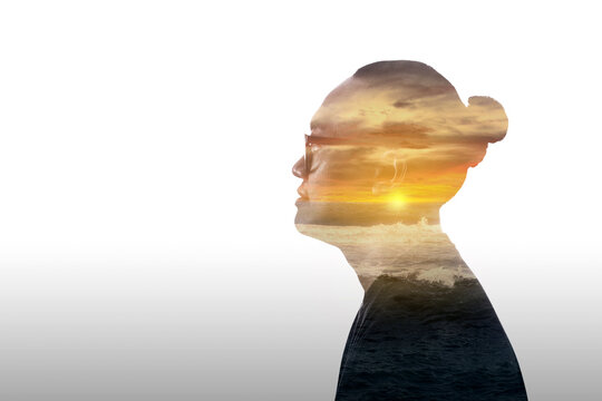 Double exposure image of a young man and sunset over the ocean