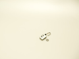 Studio shot of damaged numerical combination pad lock isolated against a white background.  
