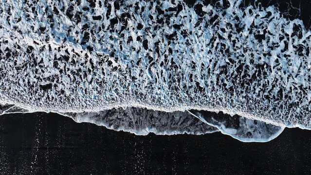 Black sand beach with crashing waves, Serene and tranquil landscape, Ocean coast with calm waves, Famous landmark of Iceland, Black sand of volcanic origin aerial view