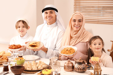 Obraz na płótnie Canvas Happy Muslim family with traditional food having dinner at home. Ramadan celebration