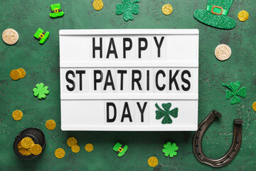 Board with words HAPPY ST PATRICKS DAY, horseshoe and decor on green grunge background