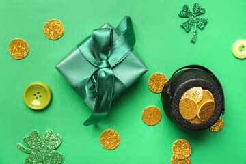 Fototapeta na wymiar Gift box with pot of golden coins and clovers for St. Patrick's Day celebration on green background