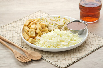 Tahu Campur, made from tofu, cabbage and bean sprouts served with peanut sauce. Indonesian traditional food

