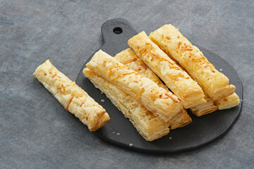 Cheese Stick Pastry served on chopping board
