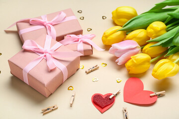 Presents, tulips and paper hearts on beige background