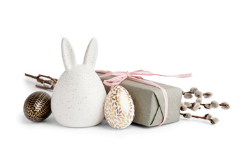 Easter eggs, bunny figure, willow branches and gift on white background