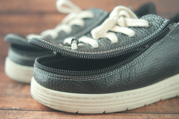 Child cerebral palsy legs orthosis shoes on table 