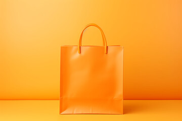 Orange paper shopping bag on orange background. Clipping path included.
