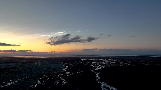 Polar Stratospheric Clouds Over Braided Channel Of River At Sunrise In South Iceland. - aerial shot